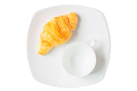 Croissant on white plate with blank mug isolated over white background. Croissant french breakfast. Top view.の写真素材