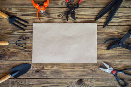 Gardening tools and set of plant care utensils on wooden table, top view, garden maintenance landscaping and hobby concept.の写真素材