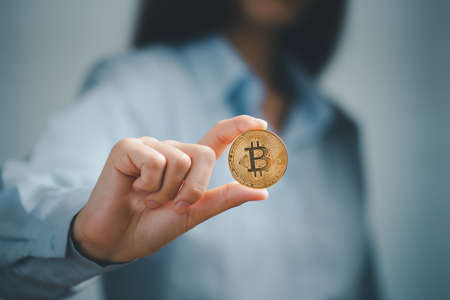 Bitcoin, Bitcoin in hand of woman, Digital cryptocurrency Online, virtual future currency concept.の写真素材