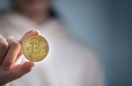 Bitcoins, Bitcoin in hand of woman, Digital cryptocurrency Online, virtual future currency concept.の写真素材