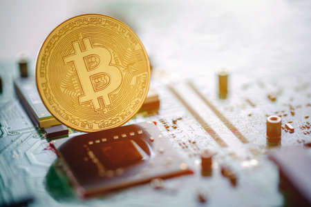 Golden coins with bitcoin symbol on mainboard. Digital cryptocurrency Online, virtual future...