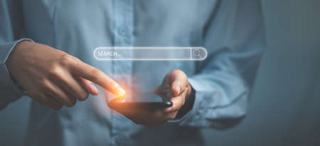 Hand people click on internet search pages on mobile phone to find what they are interested in searching for information on internet networking. Searching data information concept.の写真素材