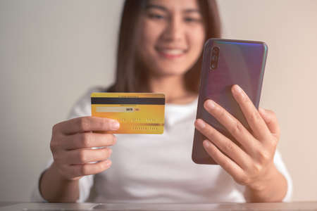 Woman shopping online with credit card and using smartphone for online shopping, Online payment concept.の写真素材