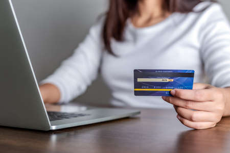 Woman shopping online with credit card and using laptop for online shopping, Online payment concept.の写真素材
