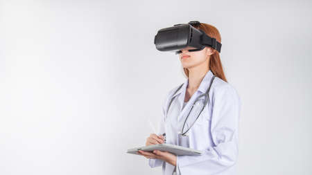 Female doctors or physician wearing virtual reality glasses, Innovative technology in science and medicine. medical and health concept.の写真素材