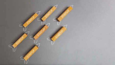 Business startup concept, Wooden block and  rocket sketch drawing on grey backgroundの写真素材