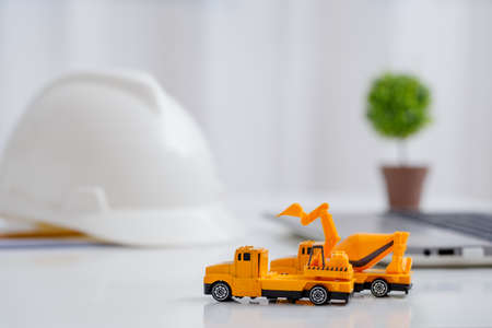 Concrete mixer truck and excavator on architect's desk, Engineering objects, Construction site.の写真素材