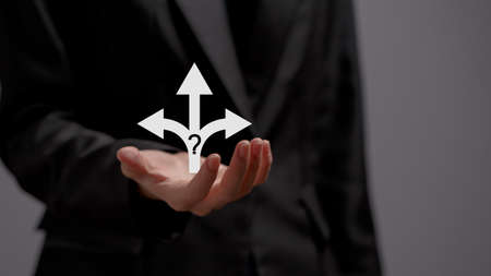 Businessman hand holding arrow symbol three alternative ways to make decisions.の写真素材