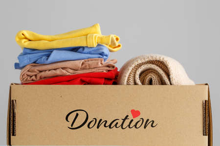 Box of clothes for donations. Clothing donation concept.の写真素材