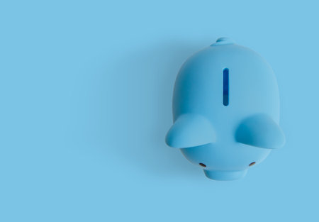 Close-up shot of top of blue piggy bank isolated on blue screen.の写真素材