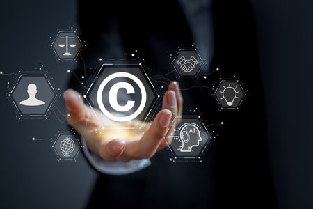 Concept of protecting and protecting against copyright infringement. The hand of a business person is holding a copyright icon.の写真素材