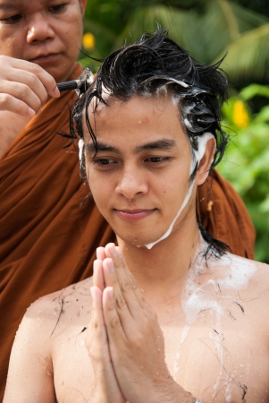 BANGKOK, THAILAND - JULY 28   Thai man gets his head shaved by a monk during a Buddhist ordination ceremony on July 28, 2012 in Bangkok, Thailand のeditorial素材
