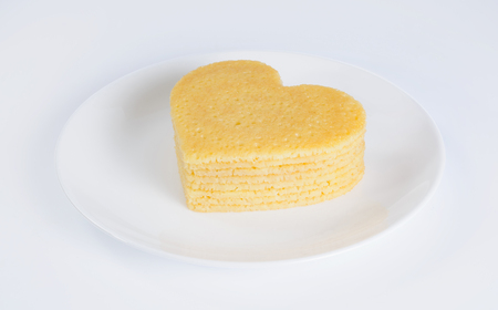 Pile of pancakes in the shape of a heart on white plateの写真素材