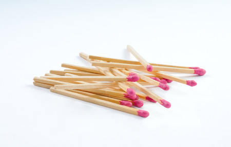 Pile of big matches with rose match head isolated on white backgroundの写真素材
