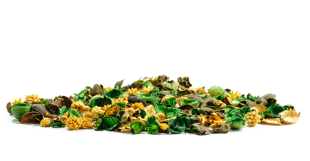 Pile of content from aromatic sachet of colored dried parts of spicy herbs isolated on white backgroundの写真素材