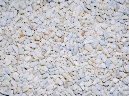 Background of well polished little mainly white stones view from aboveの写真素材