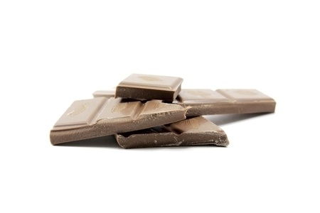 Pieces of chocolate on white backgroundの写真素材