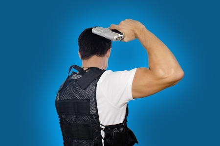 Guy with gun on blue backgroundの写真素材