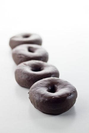 chocolate donuts isolated on white backgroundの写真素材