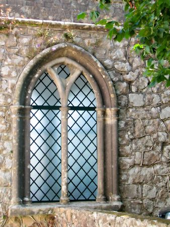 ancient stainded glass window with bushesの写真素材
