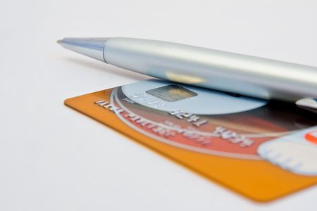 a close-up of a pen and a credit cardの写真素材