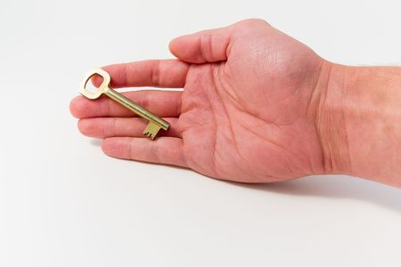 hand with a golden keyの写真素材