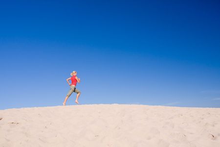 beautiful female exercising on the sand dunesの写真素材