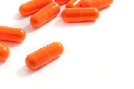 orange pills assortment on white bakcgroundの写真素材