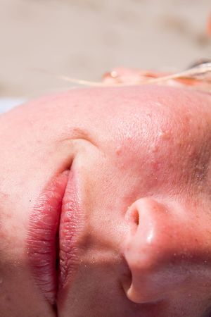 close-up of a female face on the beachの写真素材