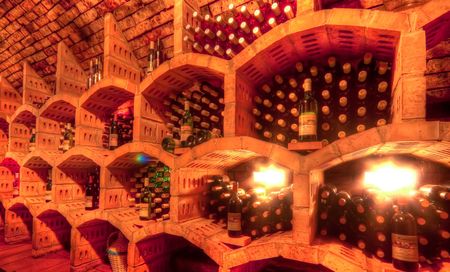 stacked up wine bottles in the cellarの写真素材