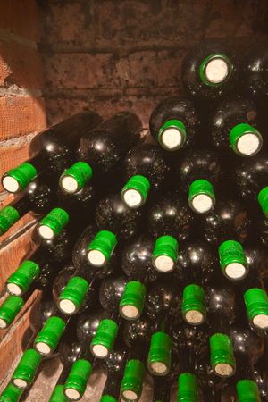 stacked up wine bottles in the cellar