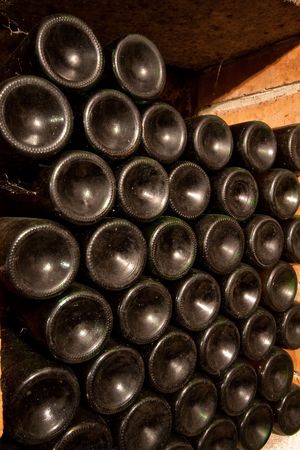 stacked up wine bottles in the cellar