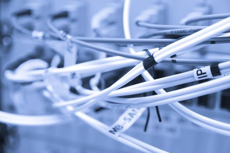 Fiber cables connected to servers in a datacenterの写真素材