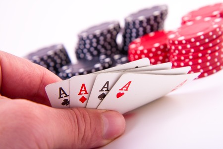 four aces with poker chips on white background