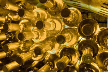 stacked up wine bottles in the wine caveの写真素材