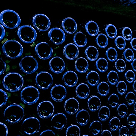 stacked up wine bottles in the cellarの写真素材