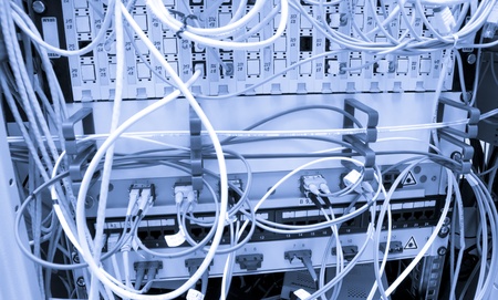 Fiber cables connected to servers in a datacenterの写真素材