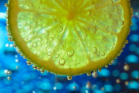 slice of lime with bubblesの写真素材