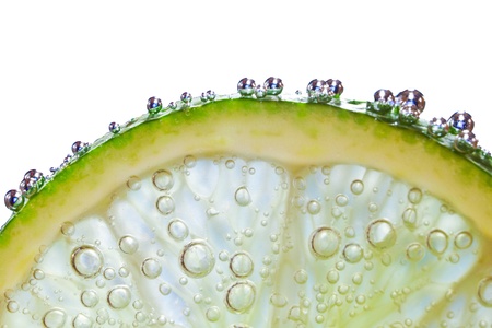 slice of lime with bubbles isolatedの写真素材