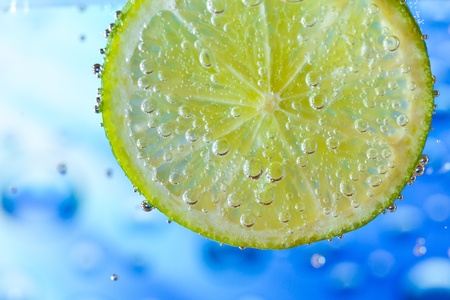 slice of lime with bubblesの写真素材