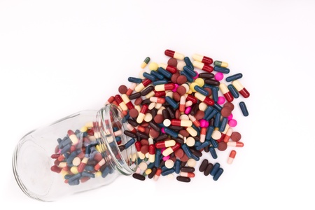 colorful tablets and capsules in glass containerの写真素材
