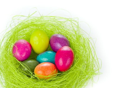 colorful easter eggs in nest isolated