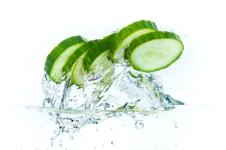 sliced cucumber splashing water isolated on white backgroundの写真素材