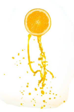 orange juice splash isolated on white backgroundの写真素材