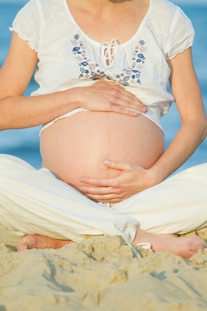 beautiful pregnant woman on a beachの写真素材