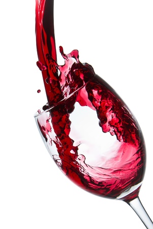 red wine pouring into wine glass isolatedの写真素材