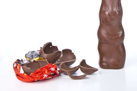 cracked chocolate egg with bunny isolated on white