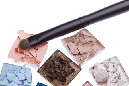 multicolored crushed eyeshadows with brush isolated on white backgroundの写真素材