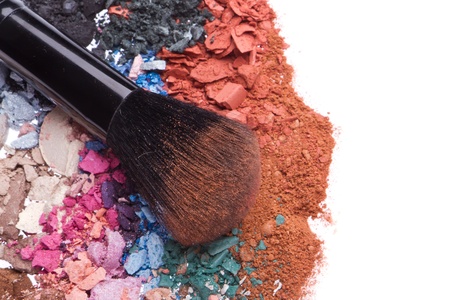 crushed eyeshadows with brush isolated on white background