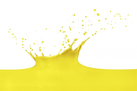 yellow paint splashing isolated on whiteの写真素材